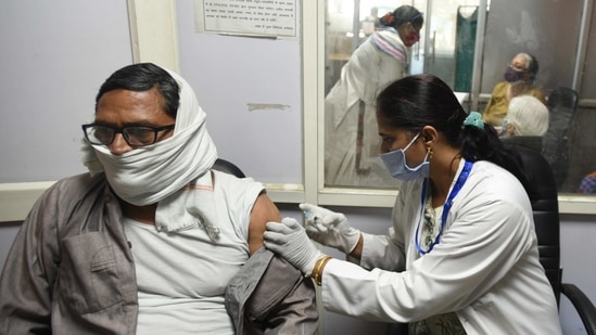 A health worker vaccinates a man against coronavrus disease (Covid-19), at District Hospital, Sector 30, in Noida on March 5. India vaccinated its highest number of people on a single day so far, on March 5 when nearly 1.5 million people were inoculated against Covid-19, HT reported.(Sunil Ghosh / HT Photo)