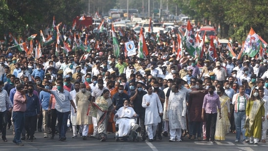 West Bengal Chief minister and All India Trinamool Congress (TMC) supremo Mamata Banerjee is seen on a wheelchair as she and a large number of TMC supporters participate in a rally on Nandigram Divas ahead of the Assembly election, at Mayo Road, in Kolkata, on March 14.(Samir Jana / HT Photo)