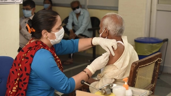 A man receives a Covid-19 vaccine at Polyclinic vaccination centre in Sector-31 near Huda market in Gurugram on April 11. India on April 10 became the third country in the world after the United States and China to have administered 100 million doses of the coronavirus vaccine.(Parveen Kumar / HT Photo)