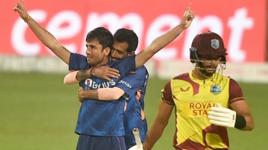 Indian bowler Ravi Bishoni celebrates with his teammate Yuzvendra Chahal after dismissing West Indies batter Brandon King (R) during 2nd T20 cricket match at Eden Garden in Kolkata, Friday,Feb. 18, 2022.(PTI)