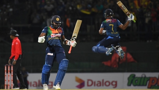 Sri Lanka's Dasun Shanaka, right, and Chamika Karunaratne celebrate their team's victory over Australia in the third Twenty20 cricket match in Pallekele, Sri Lanka, Saturday, June 11, 2022.(AP)