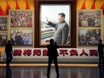 A portrait of Chinese President Xi Jinping is displayed near the words that means 