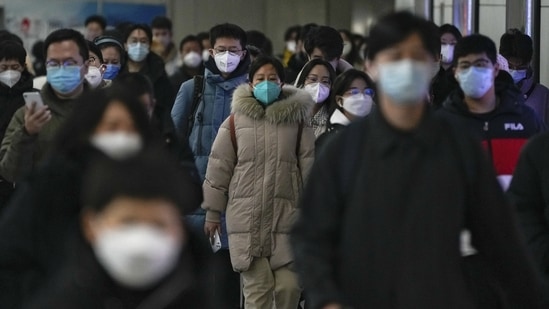 Masked commuters at a subway station during the morning rush hour in Beijing, on December 20. In wake of the Chinese government’s decision to lift the Covid curbs, cases have seen an upward rise across the country, AFP reported.(Andy Wong / AP)