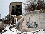 A piece by British street artist Banksy, covered with plastic, spotted in the small town of Borodyanka, some 60 km from the Ukrainian capital of Kyiv on January 12, 2023. Thousands of 