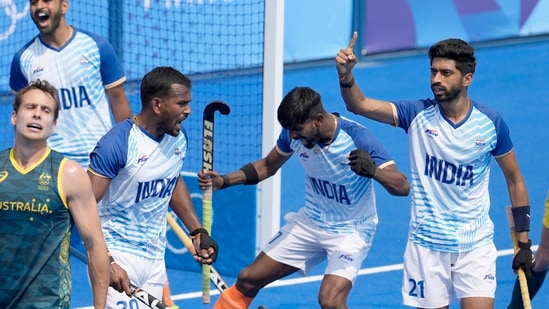 Indian players celebrate after the side clinched a historic first win over Australia in men's hockey at the Olympics in 52 years.(AP)