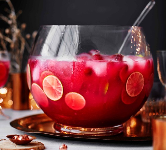 Bowl of cranberry sea breeze punch with fruit slices in