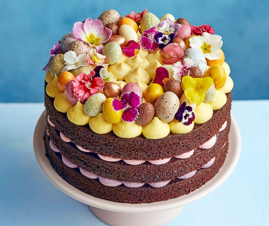 Multi-layer chocolate cake topped with icing and flowers