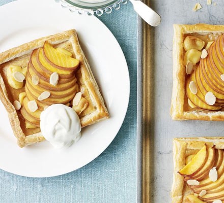Square peach tarts with ice cream on a plate