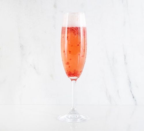Raspberry champagne cocktail in glass