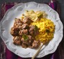 Beef rendang curry with turmeric rice on a plate