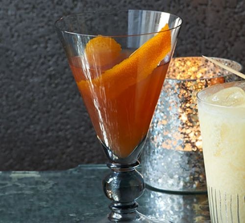 Bourbon cocktail in a glass with orange peel