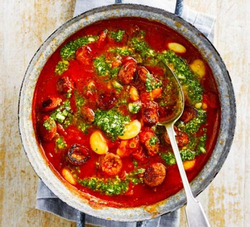 Butterbean and chorizo stew in a pot with sppon