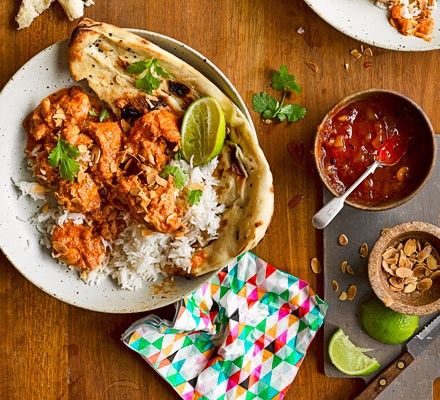 Easy butter chicken on a plate with rice and naan