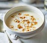 Bowl of celeriac soup topped with hazelnut croutons