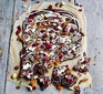 Chocolate bark with fruit and nuts on parchment paper