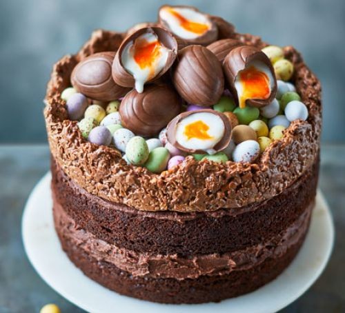 Chocolate cake topped with creme eggs and mini chocolate eggs