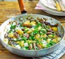 Gnocchi with mushrooms and cheese in pan