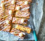 Traybake with icing and marzipan cut into slices on baking paper