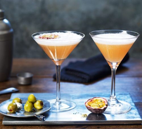 Two cocktail glasses of passionfruit martini