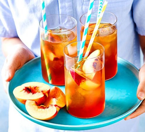 Peach iced tea in glasses on tray