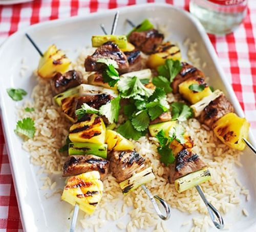 PIneapple and pork bbq skewers topped with coriander