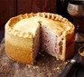 Raised pork pie with slice taken out