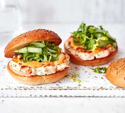 Two prawn, salmon and spicy mayo burgers with lettuce