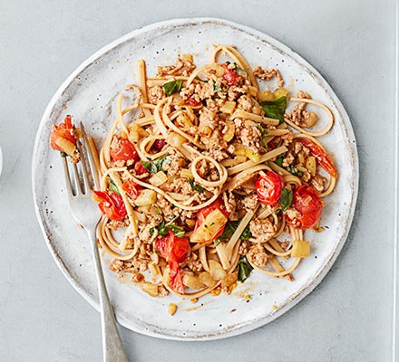 A plate serving healthy bolognese with a fork