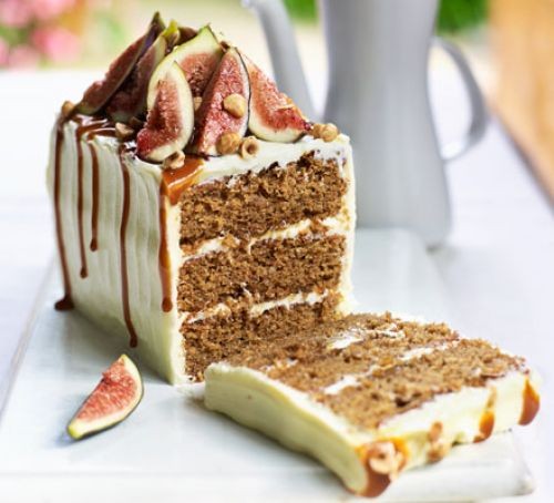 Iced coffee loaf cake with three layers, topped with figs and glaze