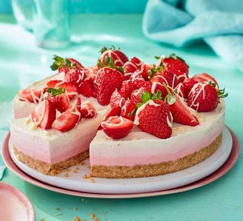 Triple coloured cheesecake topped with strawyberries