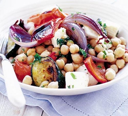 Bowl of chickpea salad with roast onions, tomatoes and feta