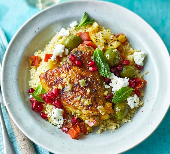 Bowl of chicken tagine with couscous and pomegranates