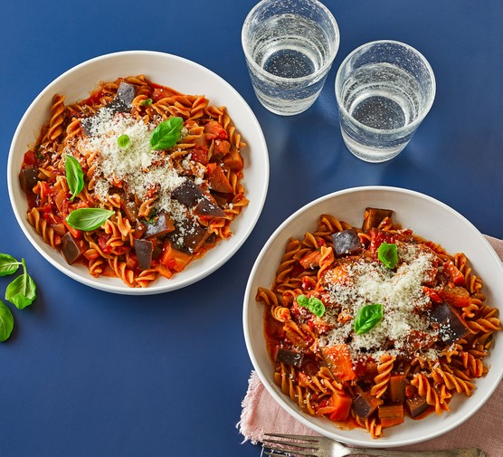 Two bowls of pasta arrabbiata with aubergines