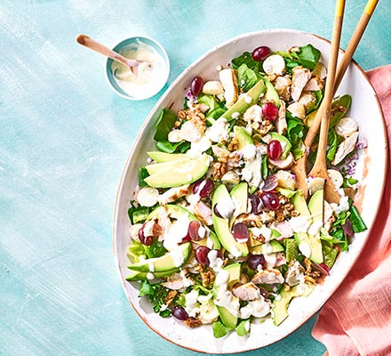 Turkey salad with grapes and walnuts on a pink platter