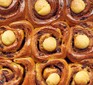 Fresh cinnamon rolls all stuck together with marzipan balls on top