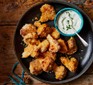 A selection of air-fryer cauliflower popcorn with soured cream & herb dressing