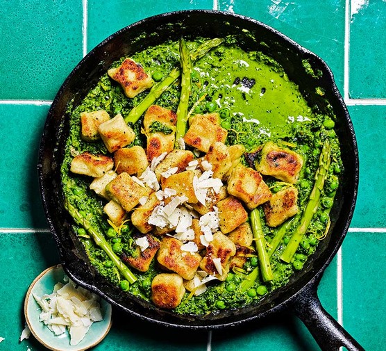 Crispy gnocchi in a frying pan with cavolo nero pesto, asparagus & peas