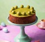 One sour cherry & pistachio simnel cake on a cake stand