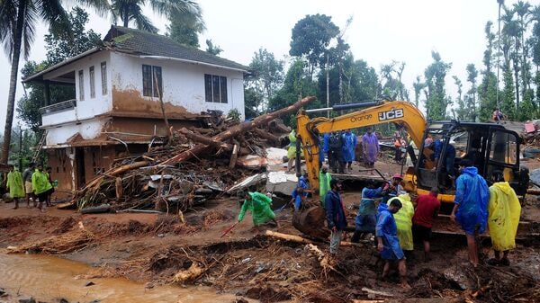 Rescuers search for survivors at a landslide site after multiple landslides in the hills in Wayanad