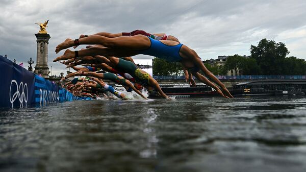 Athletes compete in the swimming race in the Seine during the women's individual triathlon at the 2024 Summer Olympics, Wednesday, 31 July 2024 in Paris, France.  (AP)