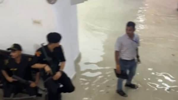 Visuals shared on social media show the Uttar Pradesh Vidhan Sabha building staff using buckets and mops to clear away the water. (Screen grab from video)