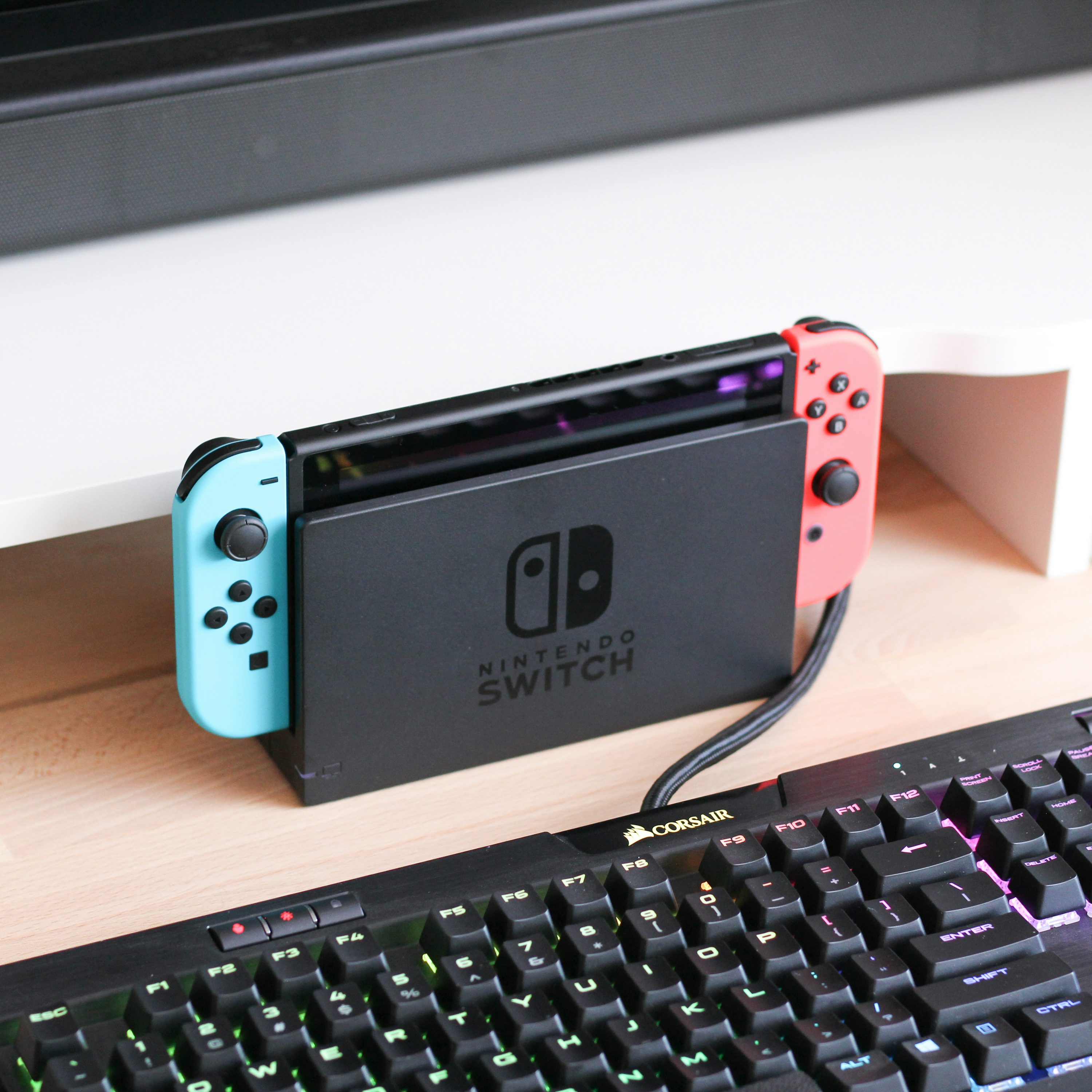 Une Nintendo Switch assise sur un bureau à côté d’un clavier