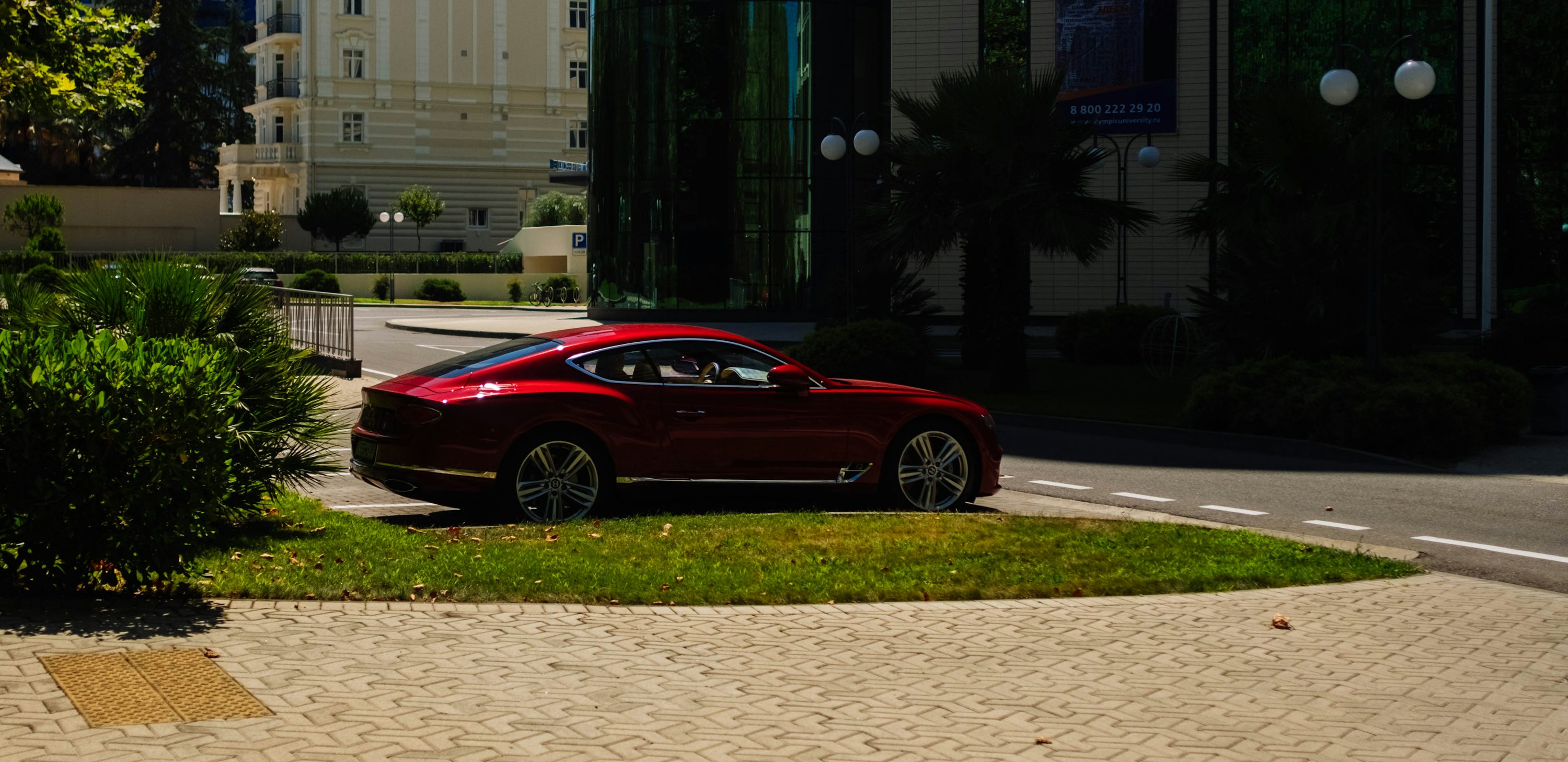 Coupé rouge stationné sur le trottoir pendant la journée