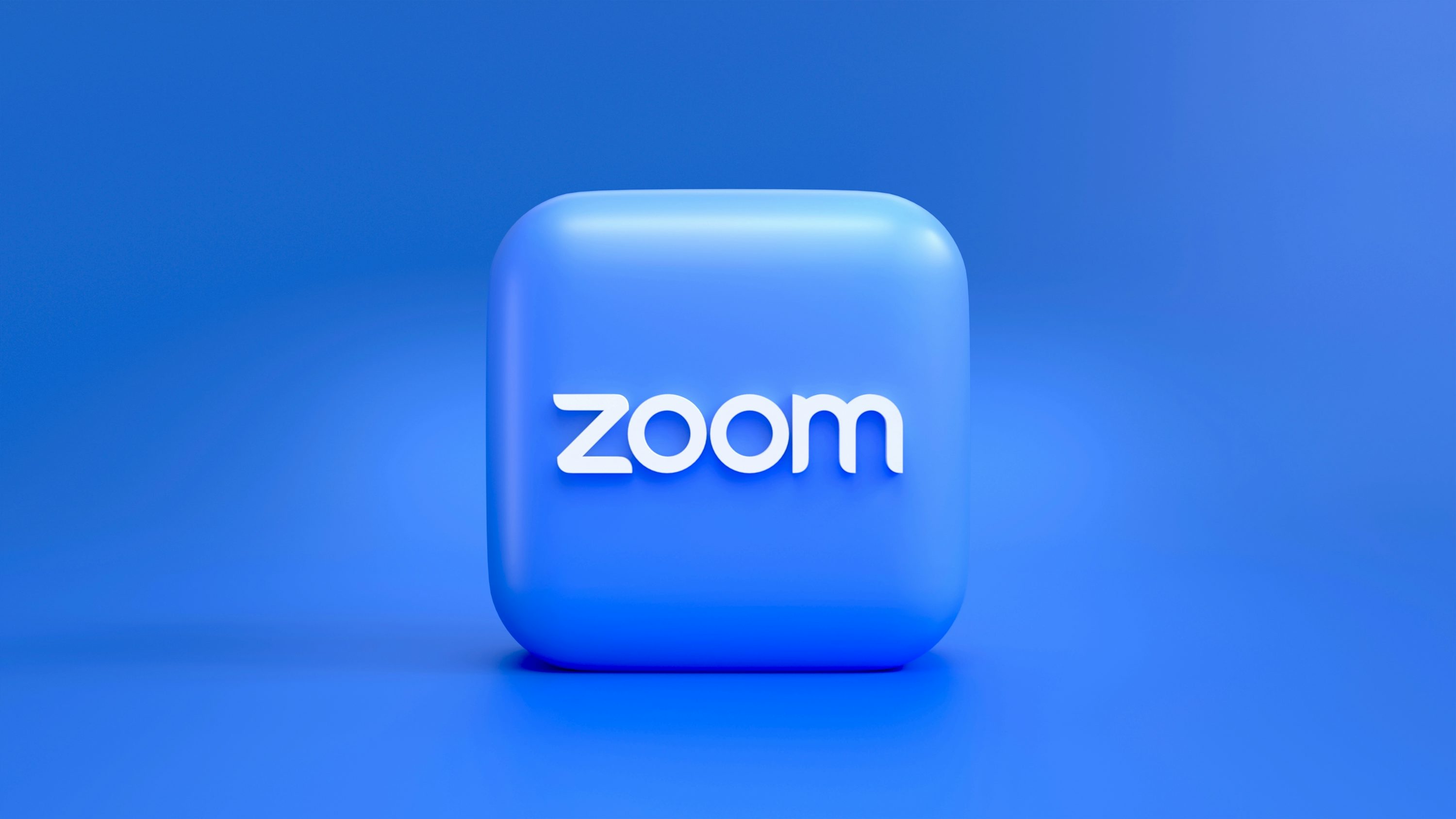 um botão quadrado azul com a palavra zoom nele