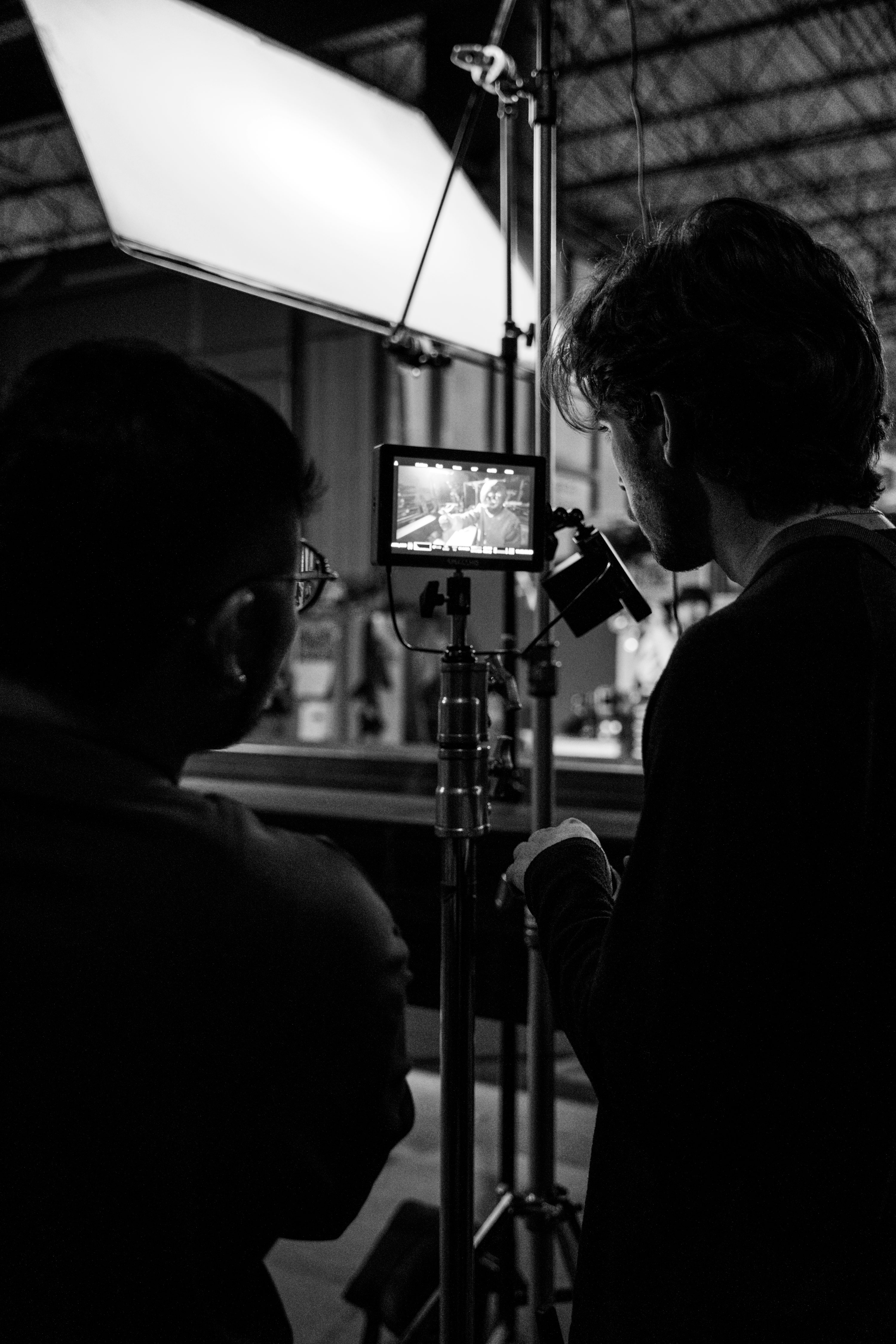 a man and a woman standing in front of a camera