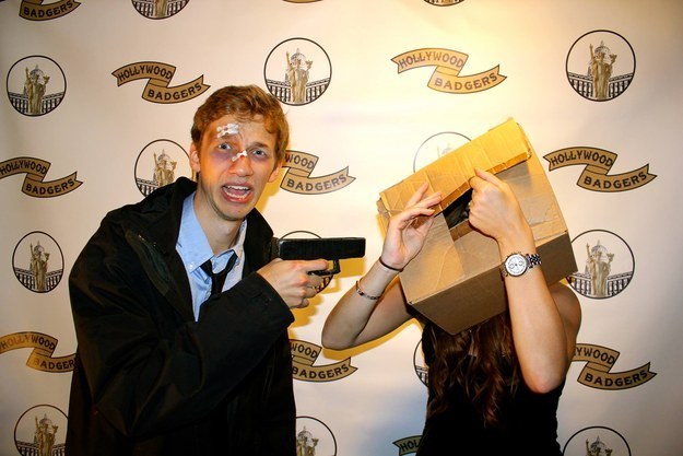 A man holding a gun to a cardboard box