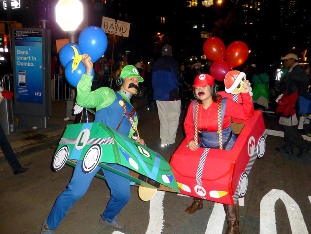 Two people in overalls with mustaches and balloons