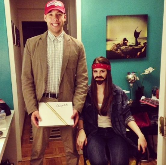 One person in a button down paid shirt and one person in a bandana and fake beard