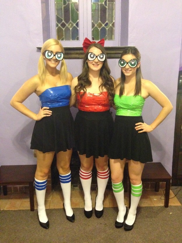 three girls in black skirts and colorful tops