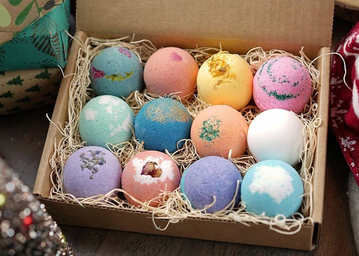 the 12 bath bombs in various colors nestled into a box